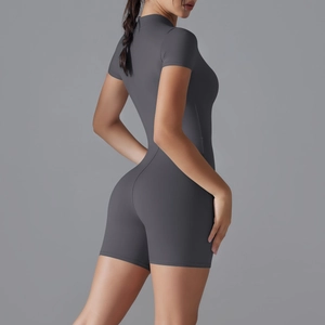 Side view of dark grey yoga romper showing sleek compression fit and athletic cut