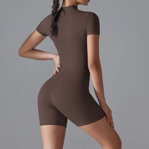 Detail of dark brown short sleeve yoga bodysuit with sleek stand collar and matte finish