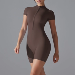 Close-up of brown slim fit yoga bodysuit featuring a metal half-zipper and stand collar