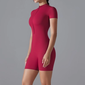 Close-up of dark red yoga romper featuring stand collar and front zipper detail