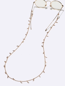 Golden eyewear chain with leaf charms and silicone loops on round glasses