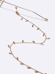 Elegant gold-tone glasses chain with delicate leaf charms and anti-slip silicone loops