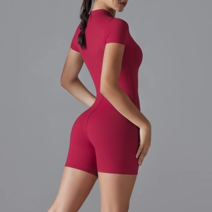 Detail view of burgundy slim fit yoga romper showing back seams and stretch fabric
