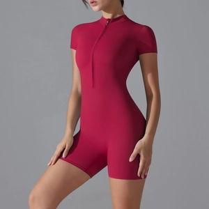 Detail of burgundy yoga bodysuit showing high collar, front zipper, and ribbed texture
