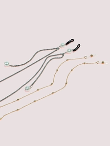 Set of two eyewear chains with silver pearl and gold bead styles on pink background