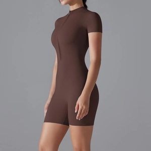 Detail view of brown athletic romper featuring a functional front zipper and mock neck collar