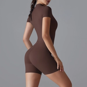 Side view of dark brown short sleeve yoga bodysuit showing athletic fit and fabric texture