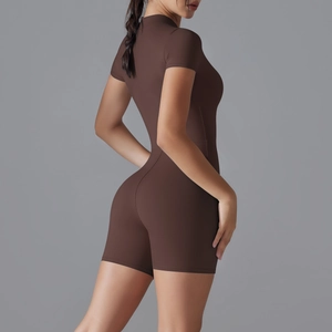 Detail view of mocha zip front short sleeve yoga bodysuit with premium stitching