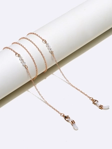 Detail of rose gold eyewear chain with clear crystals and non-slip rubber loop ends