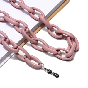 Pink acrylic thick chain link eyeglass holder and face mask lanyard on book