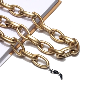 Detail of matte gold acrylic link chain with rubber loops and lobster clasps for glasses