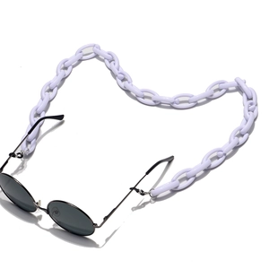 Close-up of chunky lavender acrylic eyewear chain attached to black round sunglasses
