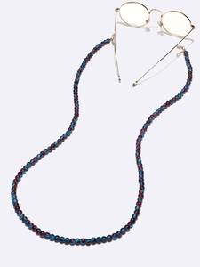 Detailed macro view of deep blue and red acrylic beads on a durable eyewear chain