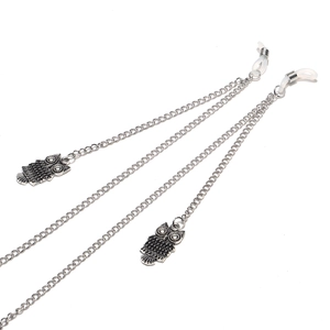 Silver metal owl pendant eyewear chain with non-slip silicone loops on white background