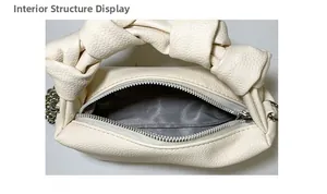 Detail of off-white leather handbag showing internal structure and chevron fabric lining