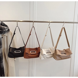 Detailed display of pleated shoulder bags in black, brown, cream and khaki with metal buckles