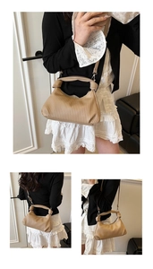 Detail of beige pleated pea bag showing accordion texture and versatile shoulder straps