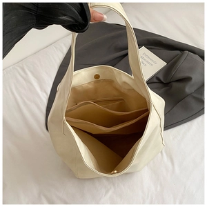 Interior detail of large tote bag showing spacious compartments and magnetic closure
