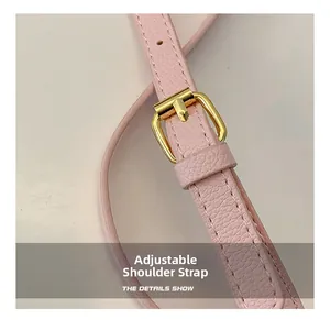 Pink embossed leather adjustable shoulder strap with gold buckle and precise stitching