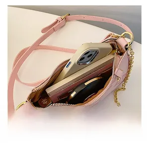 Internal view of the pink embossed clover handbag showing phone and makeup capacity