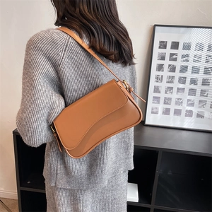 Retro caramel brown leather shoulder bag with asymmetrical flap and gold hardware