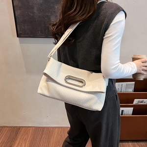 Elegante borsa a tracolla bianca a pieghe con fibbia in metallo indossata da una modella