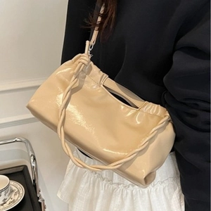 Chic cream patent leather shoulder bag with a woven handle and adjustable strap for women