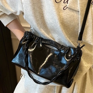 Minimalist black glossy cloud crossbody bag with pleated design and braided handle for women