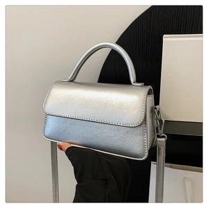 Detail showing metallic silver crinkle texture and hardware of the small crossbody bag
