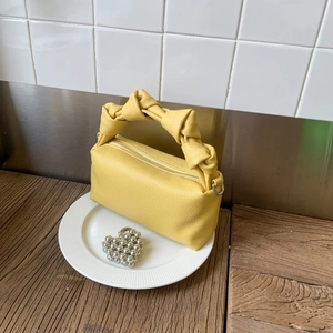 Chic yellow lychee pattern box bag featuring a creative knotted handle and top zipper