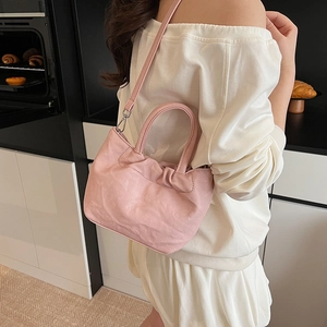 Pink ruched cloud handbag for women with soft leather texture and crossbody strap