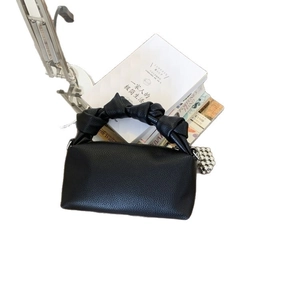 Minimalist black lychee texture handbag with knotted handle and silver ball charm decoration