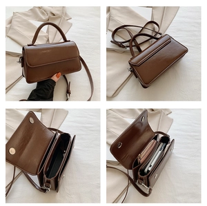 Detail view of coffee brown crossbody bag showing internal compartments and large capacity