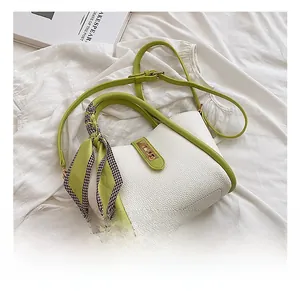 Detail of lychee pattern leather handbag with silk scarf and gold twist lock