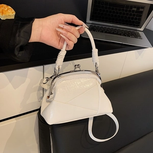 Detail of white patent leather doctor bag featuring a unique spiral-textured handle