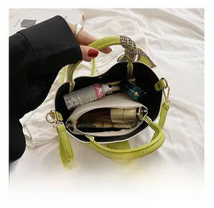 Detail view of large green hobo bag showing spacious interior with silk scarf detail