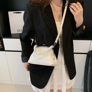 Detail of white vintage frame bag with glossy finish on a professional model