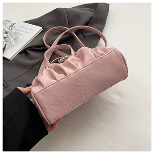 Detail of pink ruched cloud bag showing delicate PU leather texture and silver buckle