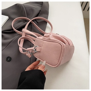 Macro shot of pink pleated vegan leather texture and silver buckle on a handbag