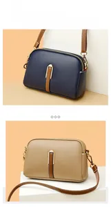Close-up of shell-shaped crossbody bags with three-layer zippers and lychee leather texture