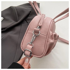 Close-up of pink PU leather bag detail featuring cute bunny ears and silver hardware