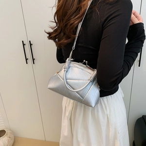 Close-up of silver quilted crossbody bag featuring a vintage doctor-style metal clasp