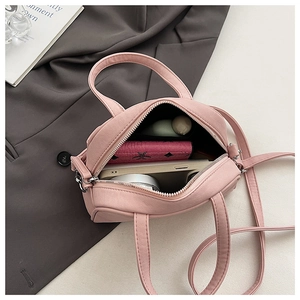 Interior view showing the large storage space for phone and makeup in the pink handbag