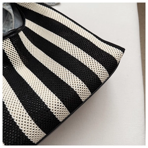 Close-up of black and white striped woven tote bag showing detailed fabric texture