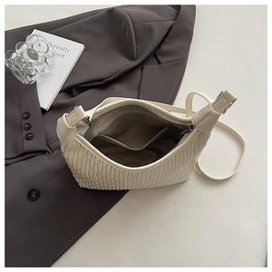 Detailed view of cream pleated shoulder bag interior showing grey lining and zipper pocket