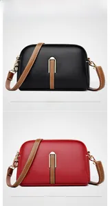 Close-up of shell-shaped crossbody bags in black and red lychee texture leather