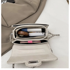 Detailed interior of quilted chain bag showing multiple compartments and storage capacity