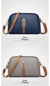 Close-up of shell-shaped cross-body bags in blue and grey with litchi grain texture