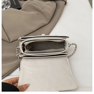 Detail view of the accordion-style interior compartments and central zipper pocket of the bag