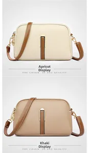 Detail view of khaki and apricot shell bags featuring textured leather and gold zippers